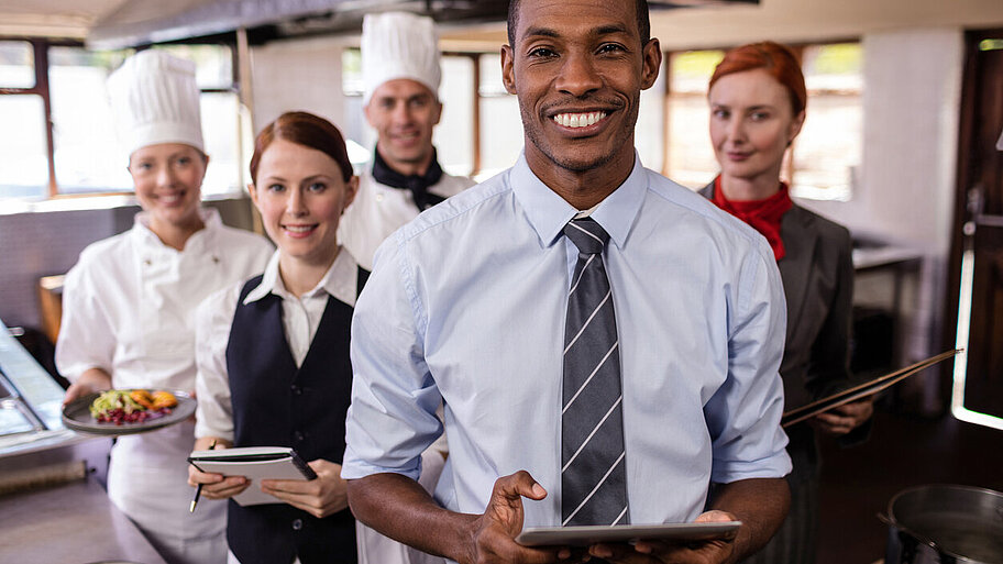 Group of hotel staffs working in kitchen